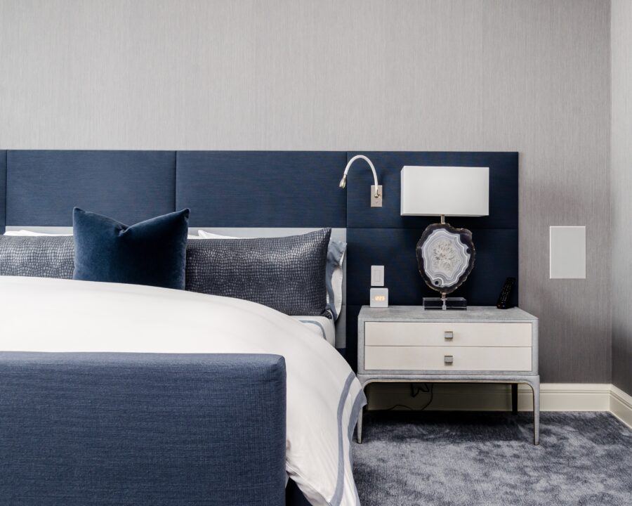 A picture featuring a hotel room, with the focus on a blue bed.