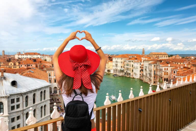 Female Traveler Tourist Over The Skyline Of Venice, Italy